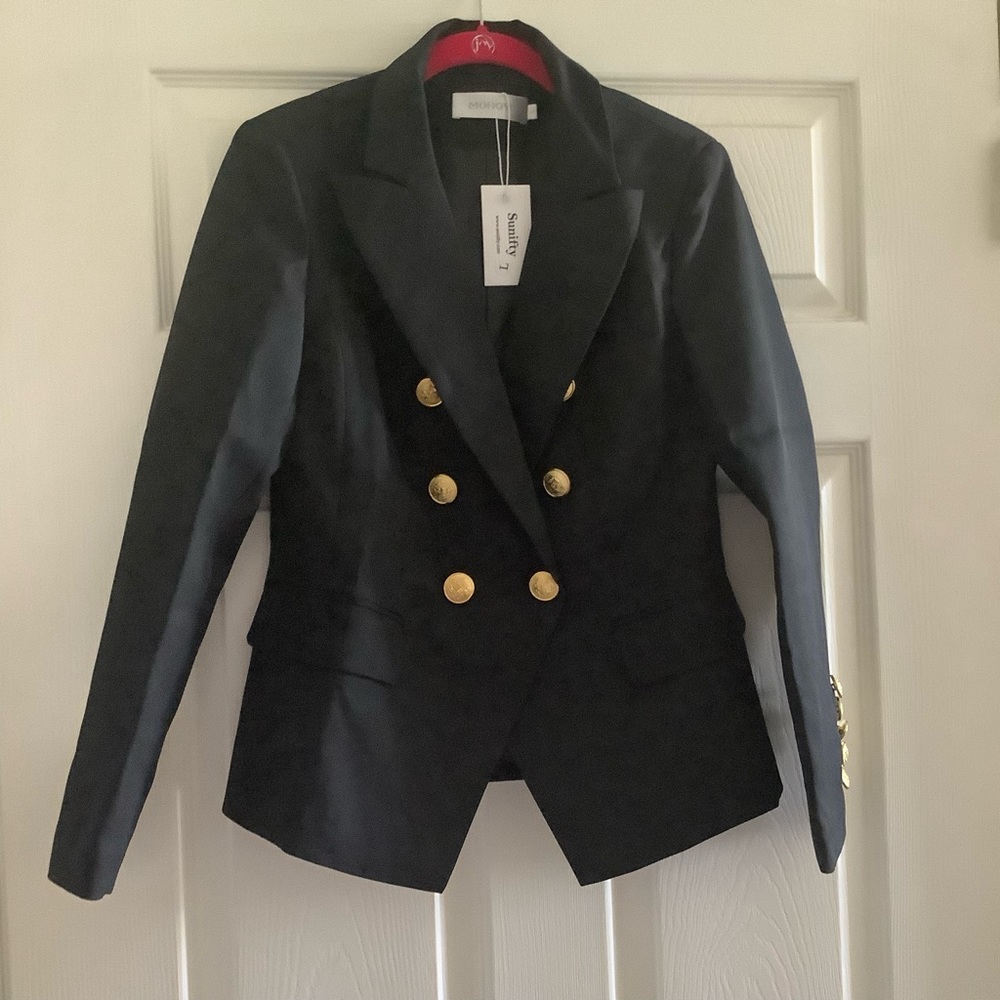 Black blazer, 2 pockets, gold buttons. Bottom button is double-breasted fasten.